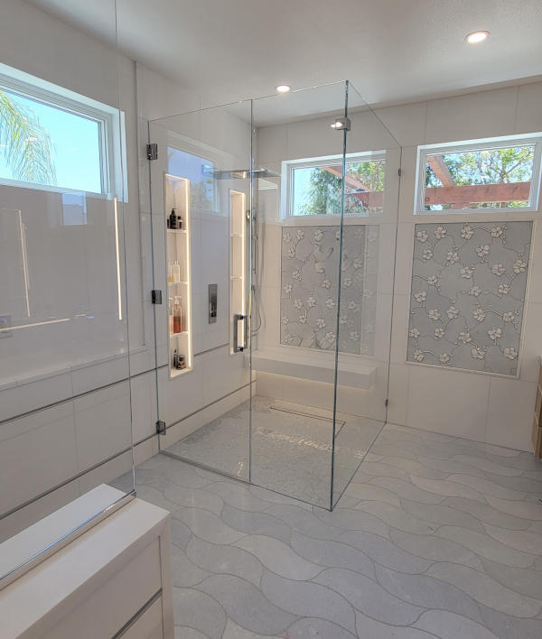 Glass-shower Frameless glass shower enclosure with built-in tile bench installed by Westoaks Glass & Mirror.