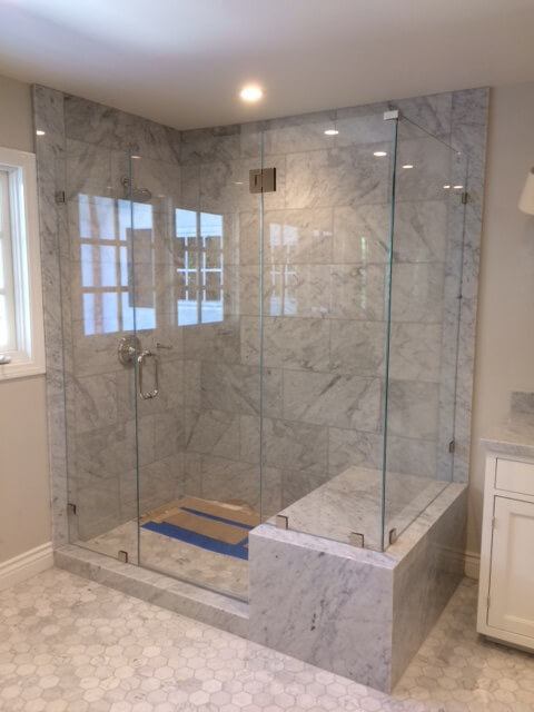 Large Glass Panel Shower Enclosure Large frameless glass panel shower with floating glass design installed by Westoaks Glass & Mirror.
