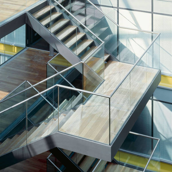 westoaks-glass-and-mirror-inc-hero-residential-railings Contemporary commercial staircase featuring sleek glass railings and metal framing designed by Westoaks Glass & Mirror.